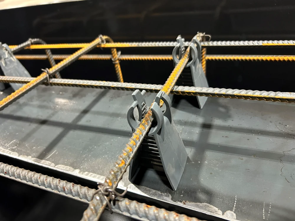 Plastic rebar chairs supporting steel reinforcement grid