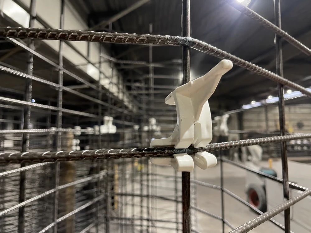 White plastic clip securing wire mesh panel