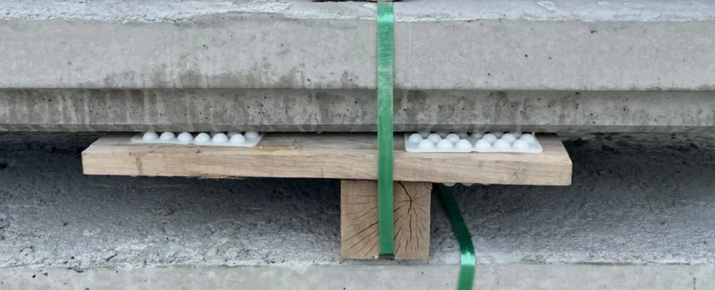 Planche de bois entre blocs de béton