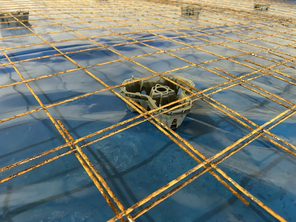 Rebar grid with plastic spacer on blue waterproofing